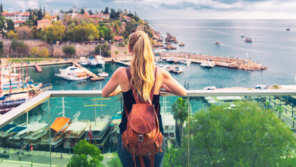 Woman tourist looking at panoramic view of harbor in the old city of Antalya, Turkey