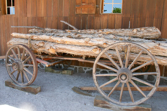 Old wooden cart next to barn