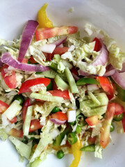 Fresh onion chopped salad pieces with green vegetables.
