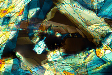 Abstract micrograph of methionine crystals that resemble a cave entrance.