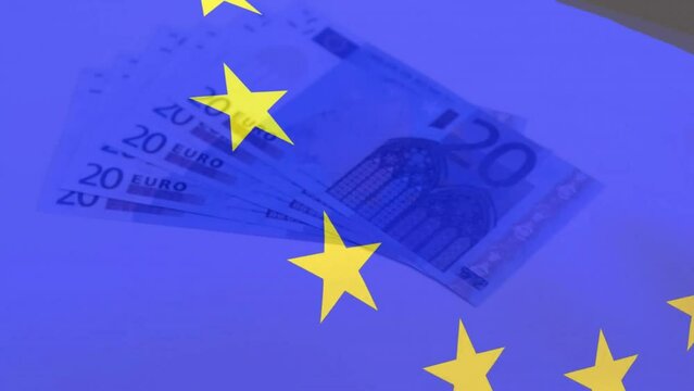 Animation of flag of european union over euro currency bills