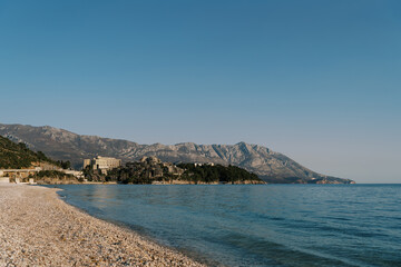 Fototapeta na wymiar Deserted main beach of Budva overlooking the mountains by the sea. Montenegro