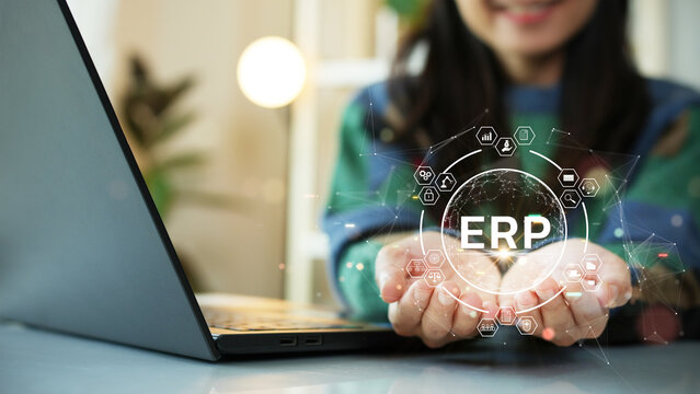 Enterprise Resource Planning (ERP). Woman uses computer work on program to help manage organization's system resources.