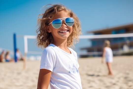 summer holidays, vacation and children concept - smiling little girl in sunglasses on beach