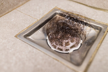 Clogged with dirty and hair over sewer pipes floor drain at bathroom