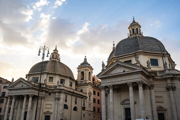Fototapeta na wymiar Scenic view of the twin churches churches of Santa Maria Montesanto and Santa Maria Miracoli in Piazza del Popolo, iconic square and major landmark in Rome