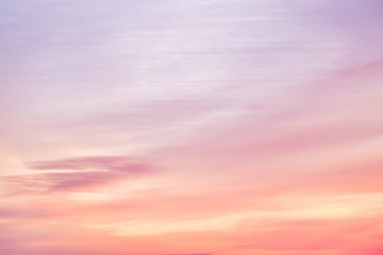 A beautiful sky tinted by the sun leaving vibrant shades of gold, pink, blue and multicolored. Clouds in the twilight evening and morning sky. Image of a cloudy sky in the evening and during the day