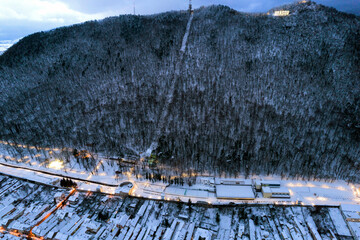 Tâmpa mountain, draped in morning snow, stands as a central figure in the city of Brașov,...