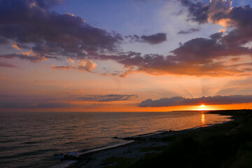 Tranquil Sunset over Dramatic Ocean Horizon