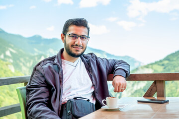 Young arab male drinking coffee during his vacation in nature