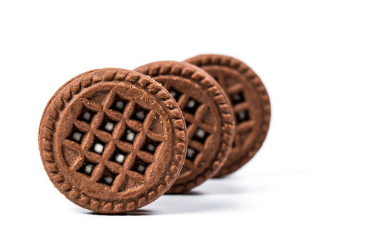 Round chocolate cookies on white background
