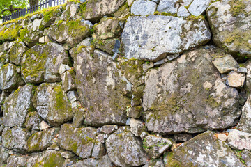 grey old stone background wall of an old building