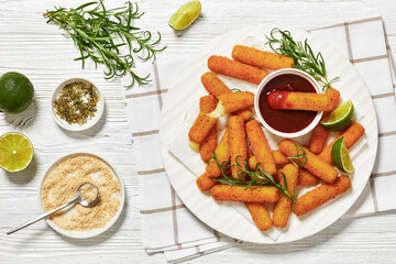 fried mozzarella sticks with sauce on white plate