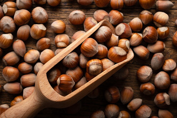 Hazelnut nuts in wooden scoop close up. Food photography