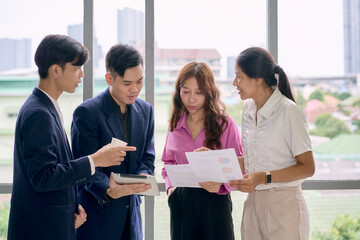 Business team working for discuss with tablet and paper chart in office and seminar room.