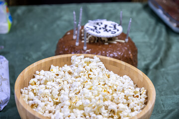 popcorn and chocolate cake on green background for birthday celebration