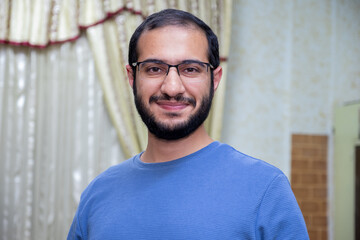 Arabic bearded male smile in home