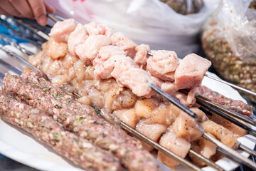 plate of meat and chicken pieces ready to be grilled