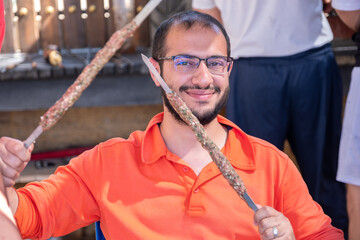 Portrait for male while preparing kebab  during holiday