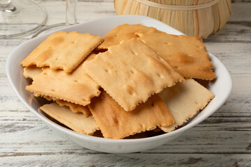 Ceramic bowl with traditional thin Italian Fornaccini crackers close up 
