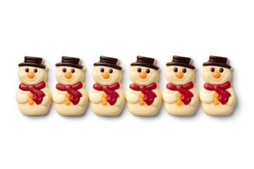 Happy white chocolate snowmen in a row isolated on white background close up