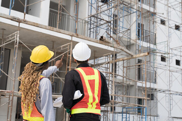 Foreman builder male and female at construction site. Group of foreman construction working at...
