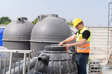 Male builder worker at construction site. Male construction engineer working and checking...