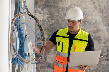 Male electrician worker checking, repair, maintenance operation electric system in construction...