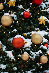 Close up of a Snow-Covered Colorful Christmas Tree Decoration