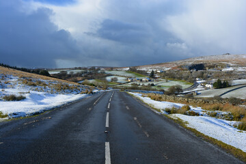 Tarmac road through rural winter landscape, Drtmoor, Devon, UK
