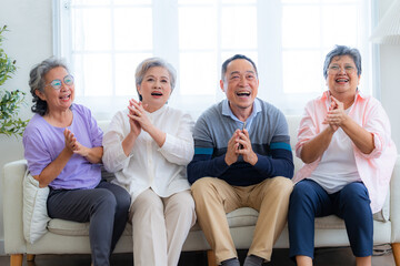 Happiness of the group females and male elderly sitting on the sofa. Senior people are talking and...