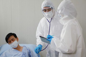 Medical team in Personal Protective Equipment or PPE clothing and Researching and Discussing Check...