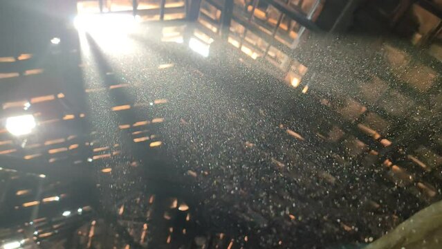 Dust particles are clearly visible to sunlight inside the warehouse