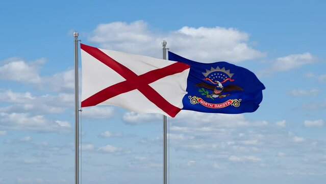 North Dakota and Alabama US state flags waving together on cloudy sky, endless seamless loop
