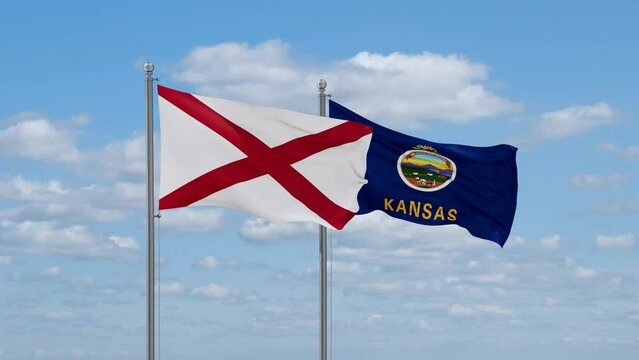 Kansas and Alabama US state flags waving together on cloudy sky, endless seamless loop