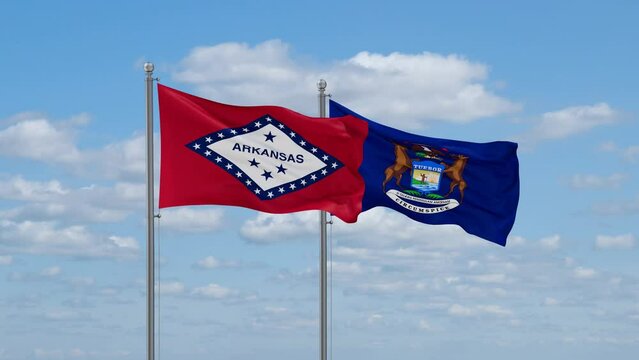 Michigan and Arkansas US state flags waving together on cloudy sky, endless seamless loop