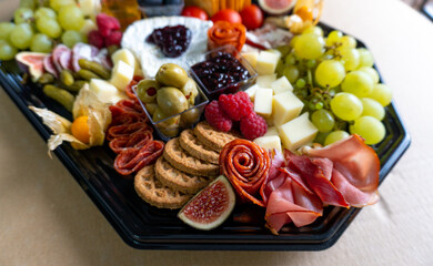 Charcuterie Board with fresh fruits, meats, and cheese