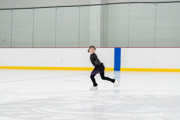 Figure skating practice at an indoor skating rink