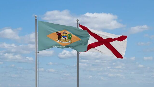 Alabama and Delaware US state flags waving together on cloudy sky, endless seamless loop