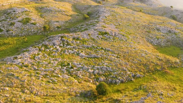 Drone footage of Sunset, Sky Meets Rocky Hilltop. 