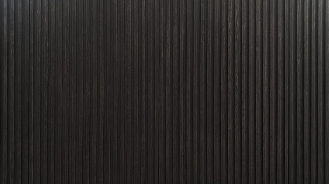 Dark brown wooden batten cabinet door as background
