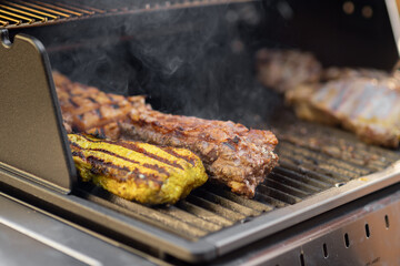 Chicken and pork steaks are grilled, close-up. Summer vacation and picnic