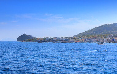 Iconic view of Ischia Island in Italy. Townscape of Ischia Ponte from sea.	