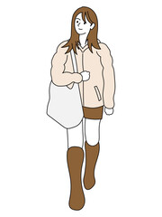 冬の街角を歩く若い女性