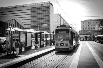 Rome, Italy - June 30, 2016: view in black and white of a tram arriving at the train station Termini in Rome on a sunny spring day - 693913290
