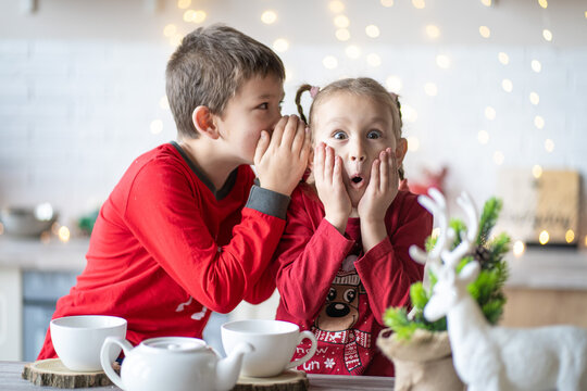 happy family funny siblings kids are preparing tea, christmas morning in the kitchen. Christmas family harmony. Christmas children in the kitchen.