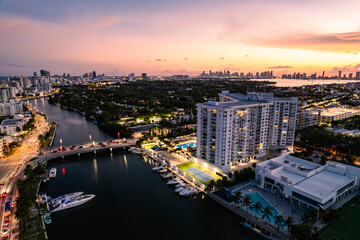 Miami Beach, Florida, USA - Evening aerial of Indian Creek and the distant Miami skyline.