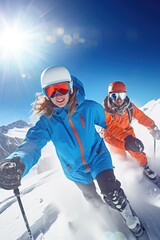 A couple of people enjoying skiing down a snow covered slope. Suitable for winter sports and...