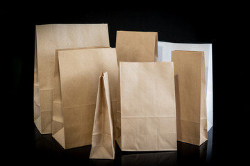 Set of paper bags for shopping on black background. Mockup for design