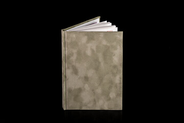 close up of a blank velour fluffy notebook on black background with clipping path